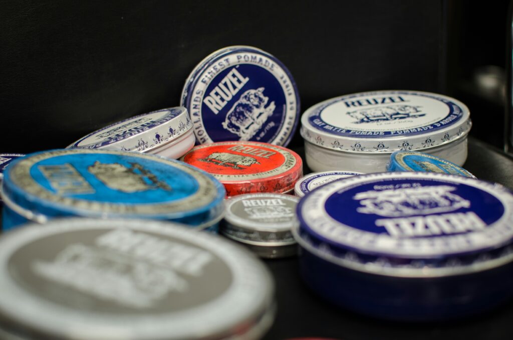 Men's hair styling products such as Pomade on a table