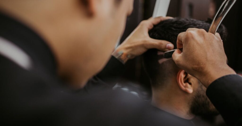 Photograph of a barber styling a man's hair