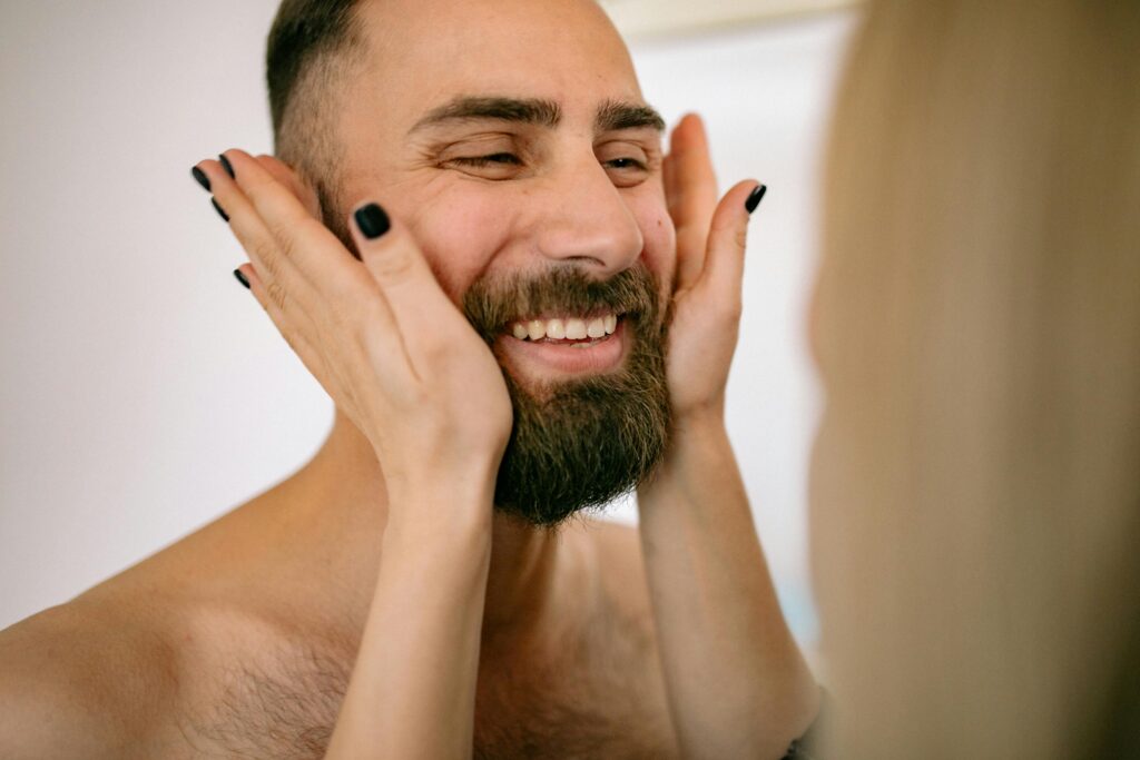 Woman Holding Hands on Face of Man